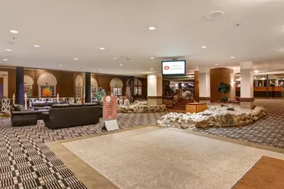 a lobby with couches and tables in a building at Edmonton Inn and Conference Centre in Edmonton