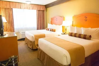 a hotel room with two beds and a window at Abercorn Hotel, Trademark Collection by Wyndham in Richmond