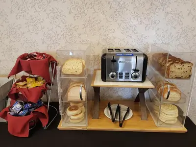 a display of bread and a toaster and a table with food at Abercorn Hotel, Trademark Collection by Wyndham in Richmond