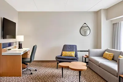 a living room with a couch and a table at Delta Hotels by Marriott Calgary Downtown in Calgary