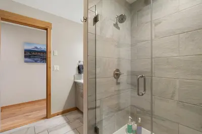 a shower with a glass door in a bathroom at Spring Creek Penthouse by Canadian Rockies Vacation Rentals in Canmore