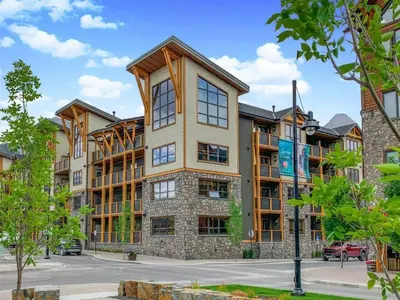 a large apartment building with a lot of windows at Spring Creek Penthouse by Canadian Rockies Vacation Rentals in Canmore