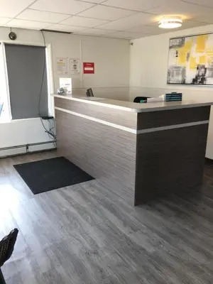 an office with a desk with a counter top at Howard Johnson by Wyndham Grande Prairie in Grande Prairie
