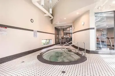 a hot tub in the middle of a building at Two Bedroom Apartment with stunning 180 water, mountain and city view Pool Hot Tub and Gym Heart of Downtown Skytrain 3mins walk Right by BC Place Rogers arena in Vancouver