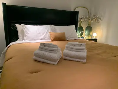 a bedroom with a bed with towels on it at White House in Vancouver