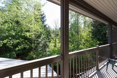 a screened in porch with a view of trees at Updated Townhouse in Village. Pool/Hot Tub/Parking in Whistler