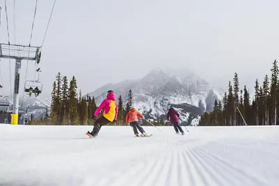 a group of people skiing on a ski slope at Banff Gate vacation townhouse in Canmore