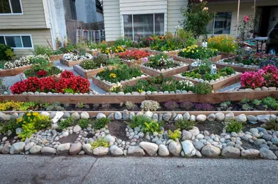 a garden with flowers and rocks in front of a house at Guest Suite Private Retreat for 2 Guests With AC - 4 Units Available in Abbotsford