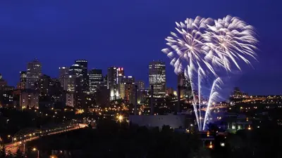 a fireworks display in front of a city at night at Stylish Chic Home - King Bed - Free Parking & Netflix - Fast Wi-Fi - Long Stays Welcome in Edmonton