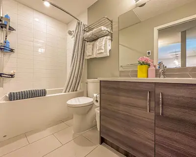 a bathroom with a toilet and a tub and a sink at Family Mountain Escape - Three Townhouses in One in Canmore