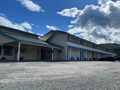 a building with a parking lot in front of it at Y-5 Motel in Barrière