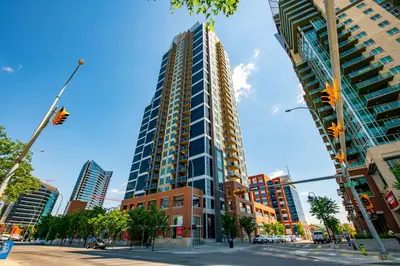 a tall building on the corner of a city street at GlobalStay Downtown Calgary Condos in Calgary