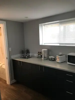 a kitchen with a counter top and a microwave at 94 Motel & RV Park in One Hundred Mile House