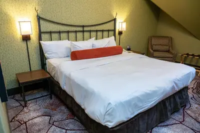 a bed in a hotel room with a large white bed at Banff Caribou Lodge and Spa in Banff