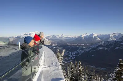 two children standing on top of a snow covered mountain at Banff Park Lodge in Banff