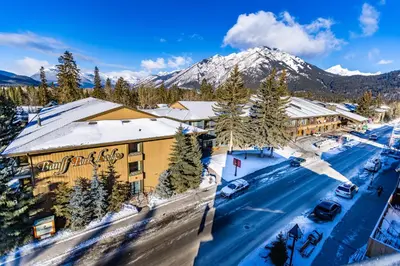 an aerial view of a resort in the snow with a mountain at Banff Park Lodge in Banff