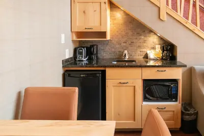 a small kitchen with a sink and a dishwasher at Fox Hotel and Suites in Banff