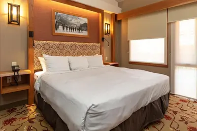 a large white bed in a hotel room at Banff Ptarmigan Inn in Banff