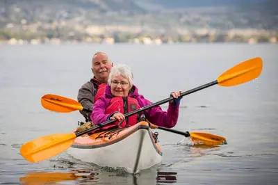 a man and a woman in a kayak on a lake at Grandma's Elephant Hideaway in Penticton
