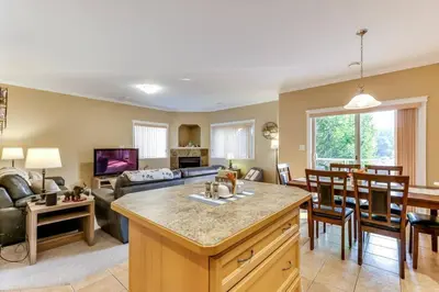 a kitchen and living room with a couch and a table at Grandma's Elephant Hideaway in Penticton
