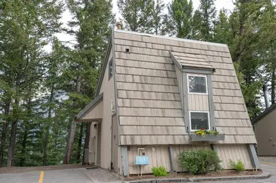 a house with a window on the side of it at Tunnel Mountain Resort in Banff