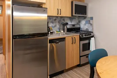 a kitchen with a stainless steel refrigerator and a stove at Tunnel Mountain Resort in Banff
