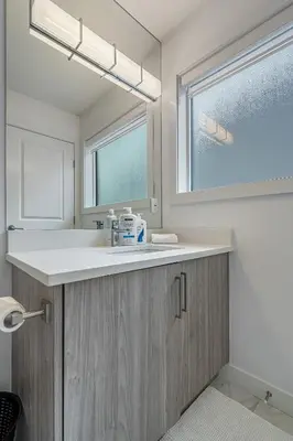 a bathroom with a sink and a window at Luxury Spacious Private House near City Centre in Calgary