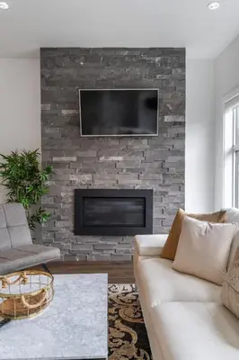 a living room with a couch and a fireplace at Contemporary Luxury 4 bedroom House near Downtown in Calgary