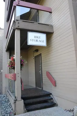 a building with a sign that reads bike storage at Tantalus Resort Lodge in Whistler