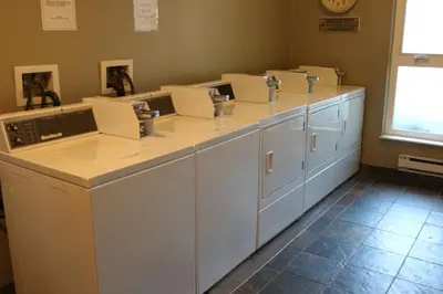 a row of white washing machines in a room at Tantalus Resort Lodge in Whistler