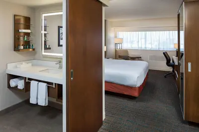 a hotel room with a bed and a sink at Delta Hotels by Marriott Calgary South in Calgary