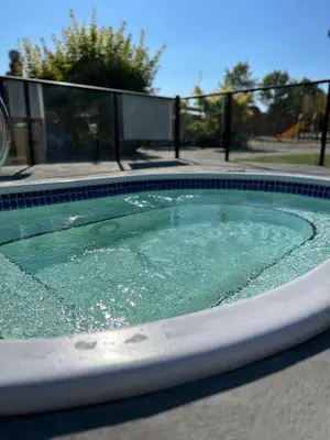 a swimming pool with green water in it at Exceptional Boutique Cottage with Incredible Lake View in Kelowna