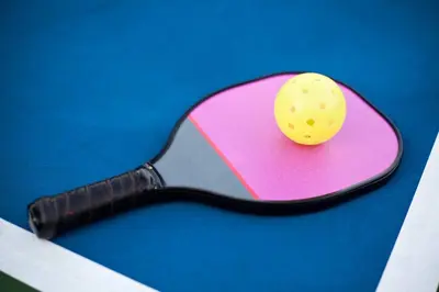 a tennis racket with a ball on a pink paper at Exceptional Boutique Cottage with Incredible Lake View in Kelowna