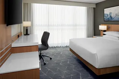 a hotel room with a bed and a desk at Delta Hotels Calgary Airport In-Terminal in Calgary