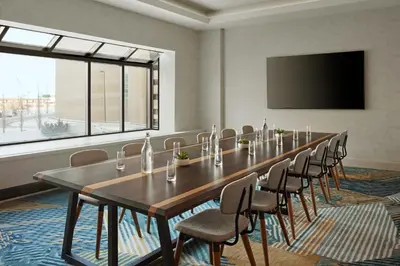a conference room with a long table and chairs at Delta Hotels Calgary Airport In-Terminal in Calgary