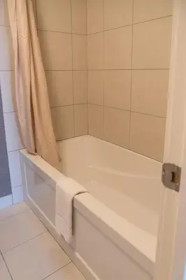 a white bath tub with a towel in a bathroom at Irwin's Mountain Inn in Banff