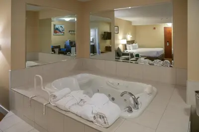 a bath tub with towels in a hotel room at Irwin's Mountain Inn in Banff