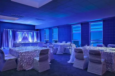 a banquet room with tables and chairs with white tablecloths at Aloft Hotel Calgary University in Calgary