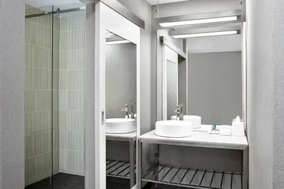 a bathroom with two sinks and a shower at Aloft Hotel Calgary University in Calgary