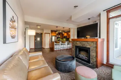 a living room with a couch and a fireplace at Blackstone Mountain Lodge by CLIQUE in Canmore