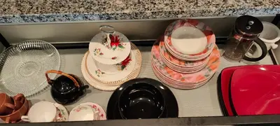 a drawer filled with plates and bowls and plates at WaterFalls Hotel - Suite in Falls Downtown with pool in Victoria