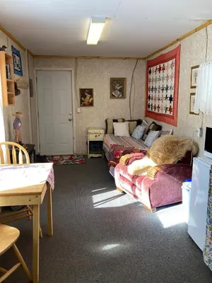 a bedroom with a bed and a couch and a table at Jade City Bungalow in Jade City