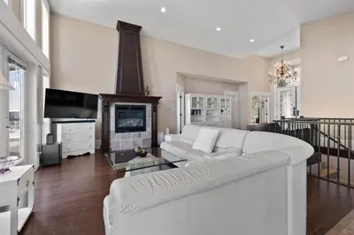 a living room with a white couch and a fireplace at Seaview Executive Home in Ladysmith