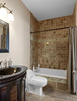 a bathroom with a tub and a toilet and a sink at Seaview Executive Home in Ladysmith
