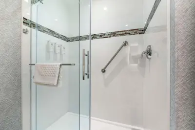 a bathroom with a shower with a glass door at Best Western Premier Route 97 Vernon in Vernon