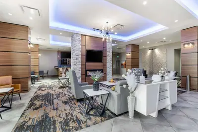 a lobby with a waiting area with chairs and tables at Best Western Premier Route 97 Vernon in Vernon