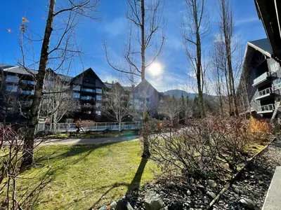 a view of a park with buildings and trees at Best ski in ski out condo at Whistler in Whistler