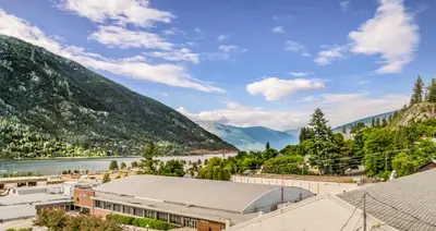a view of a town with a river and mountains at Stirling All Suites Hotel in Nelson
