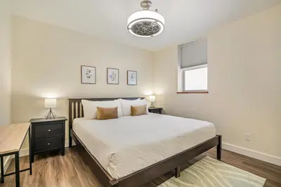 a bedroom with a large bed and a window at Stirling All Suites Hotel in Nelson