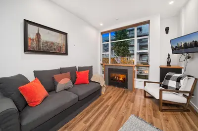 a living room with a couch and a fireplace at Luxury and Modern Studio at Blackcomb base in Whistler